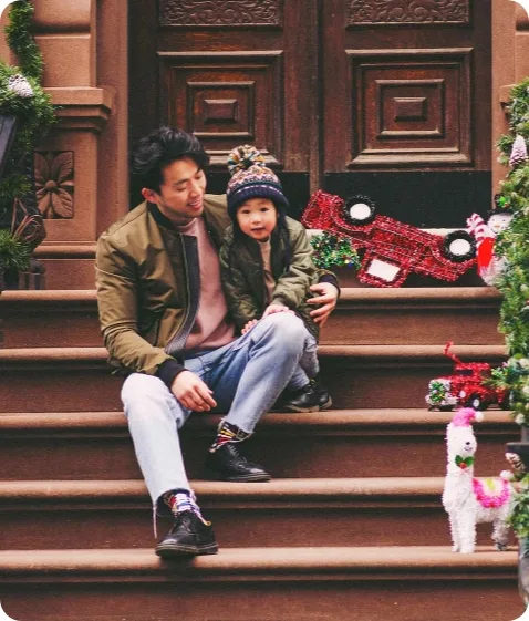 Dr. Lin Sitting on stairs with child