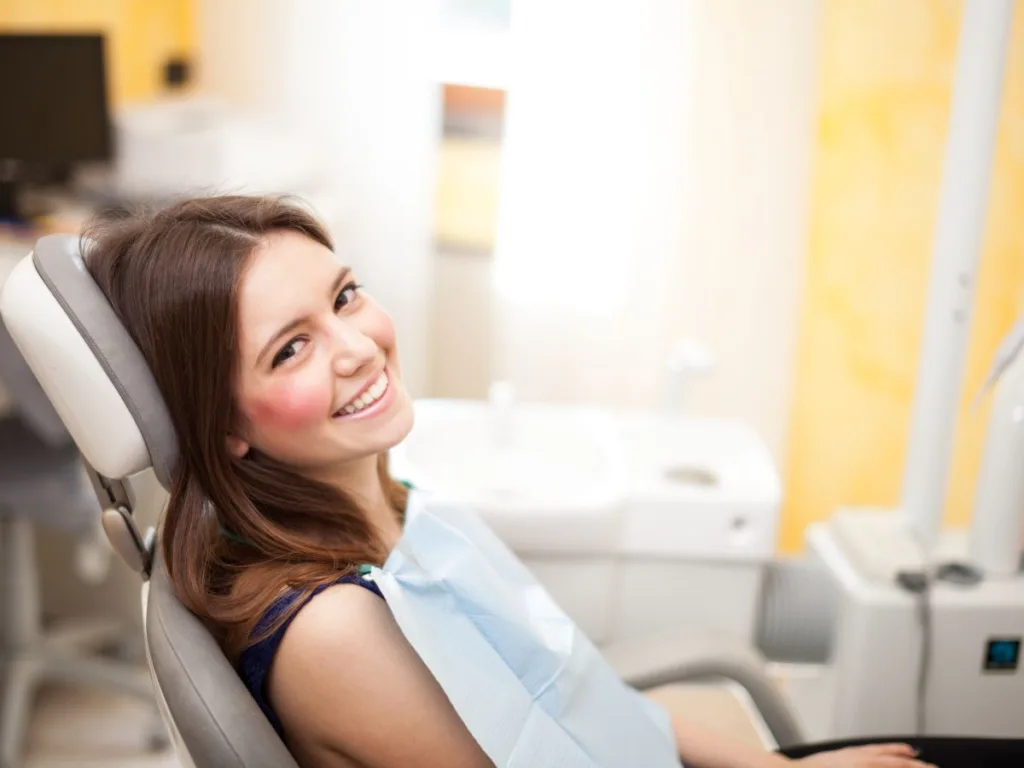 woman at dentist for dental cleanings with braces